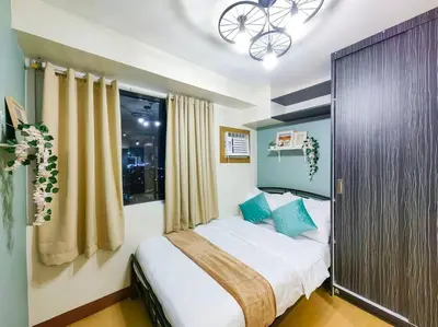 a bedroom with a bed and a window at 1BR Condotel Ridgewood Towers Taguig City #RW06 in Manila