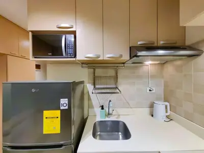 a small kitchen with a sink and a microwave at 1BR Condotel Ridgewood Towers Taguig City #RW06 in Manila