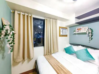 a bedroom with a bed and a window at 1BR Condotel Ridgewood Towers Taguig City #RW06 in Manila
