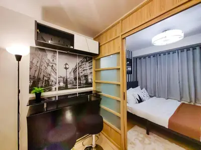 a bedroom with a bed and a desk in a room at 1BR Condotel Ridgewood Towers Taguig City #RW07 in Manila