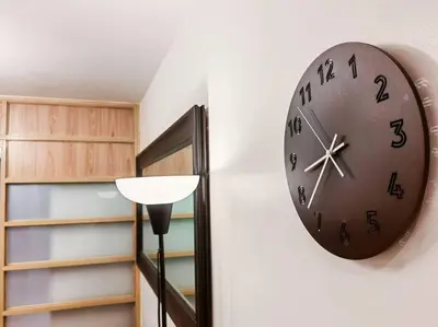 a clock hanging on a wall next to a shelf at 1BR Condotel Ridgewood Towers Taguig City #RW07 in Manila