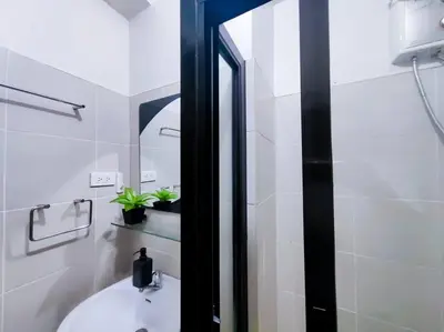 a bathroom with a sink and a mirror at 1BR Condotel Ridgewood Towers Taguig City #RW07 in Manila