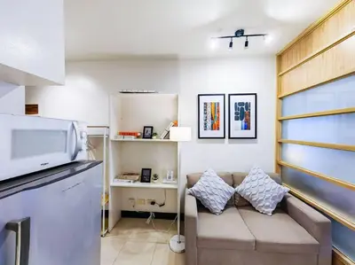 a living room with a couch and a microwave at 1BR Condotel Ridgewood Towers Taguig City #RW09 in Manila
