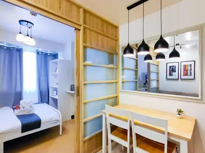 a bedroom with a desk and a bed and a mirror at 1BR Condotel Ridgewood Towers Taguig City #RW09 in Manila