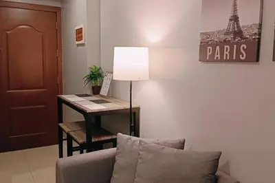a living room with a desk with a lamp and a couch at 1BR Condotel Ridgewood Towers Taguig City #RW10 in Manila