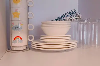 a pile of plates and bowls on a shelf at 1BR Condotel Ridgewood Towers Taguig City #RW10 in Manila