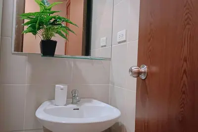 a bathroom with a sink and a potted plant at 1BR Condotel Ridgewood Towers Taguig City #RW10 in Manila