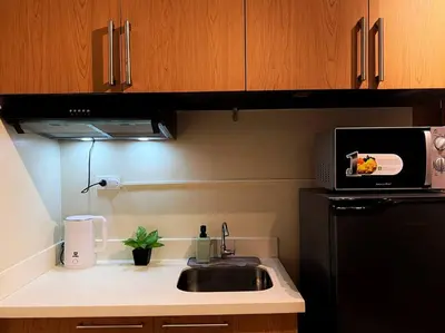 a kitchen with a sink and a microwave at 1BR Condotel Ridgewood Towers Taguig City #RW11 in Manila