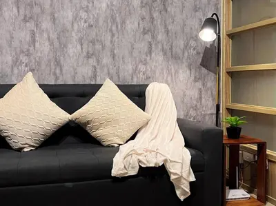 a black couch with a blanket on top of it at 1BR Condotel Ridgewood Towers Taguig City #RW11 in Manila
