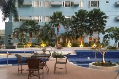 a patio with chairs and a table in front of a building at 1BR Condotel Ridgewood Towers Taguig City #RW11 in Manila