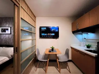 a small kitchen with a small table in a room at 1BR Condotel Ridgewood Towers Taguig City #RW11 in Manila