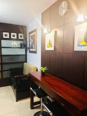 a room with a wooden table and a desk at 1BR Condotel Ridgewood Towers Taguig City #RW12 in Manila