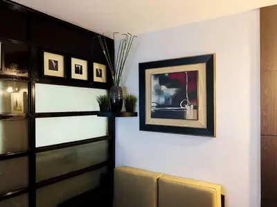 a living room with a couch and a picture on the wall at 1BR Condotel Ridgewood Towers Taguig City #RW12 in Manila