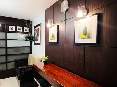 a office with a wooden wall with a desk and pictures at 1BR Condotel Ridgewood Towers Taguig City #RW12 in Manila