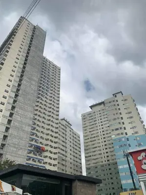 two tall buildings in a city with a crane at 1BR Condotel Ridgewood Towers Taguig City #RW12 in Manila
