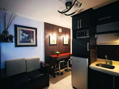 a kitchen with a sink and a table in it at 1BR Condotel Ridgewood Towers Taguig City #RW12 in Manila