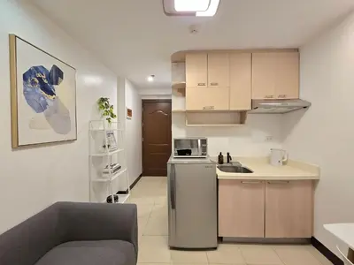 a small kitchen with a sink and a refrigerator at 1BR Condotel Ridgewood Towers Taguig City #RW13 in Manila