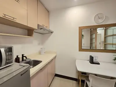a white kitchen with a sink and a mirror at 1BR Condotel Ridgewood Towers Taguig City #RW13 in Manila