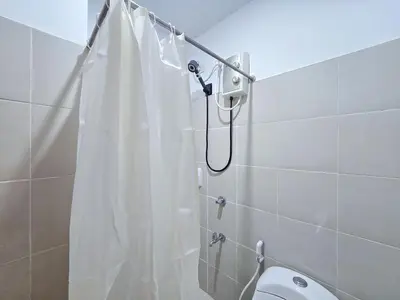 a shower with a white shower curtain in a bathroom at 1BR Condotel Ridgewood Towers Taguig City #RW13 in Manila