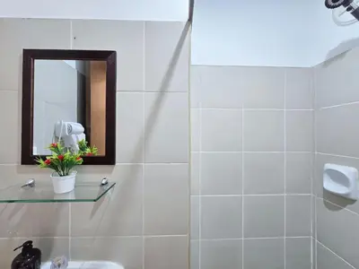 a bathroom with a mirror and a sink at 1BR Condotel Ridgewood Towers Taguig City #RW13 in Manila