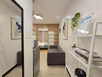 a living room with a couch and a bedroom at 1BR Condotel Ridgewood Towers Taguig City #RW13 in Manila
