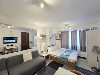 a living room with a couch and a bed at 1BR Condotel Ridgewood Towers Taguig City #RW14 in Manila