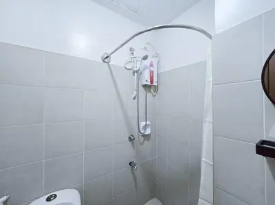a bathroom with a shower and a toilet in it at 1BR Condotel Ridgewood Towers Taguig City #RW14 in Manila