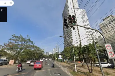 a traffic light with cars and motorcycles on a city street at 1BR Condotel Ridgewood Towers Taguig City #RW14 in Manila