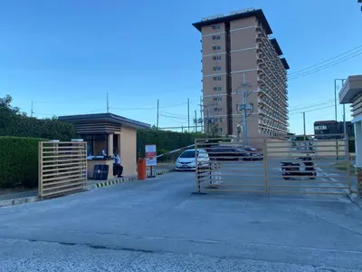 a parking lot with parked cars and a building at Kral Suite in Las Piñas in Manila
