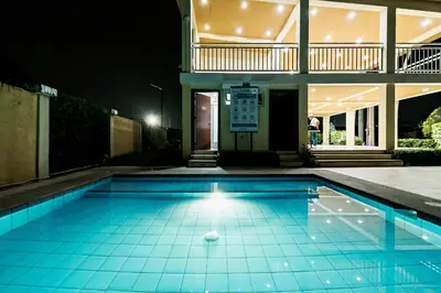 a swimming pool at night with a ball in it at Kral Suite in Las Piñas in Manila