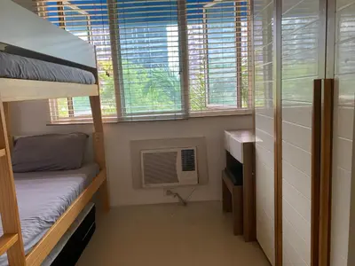a dorm room with a bunk bed and a window at Your Happy Home in Mall of Asia in Manila