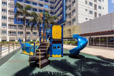 a playground in a building with a slide at Your Happy Home in Mall of Asia in Manila