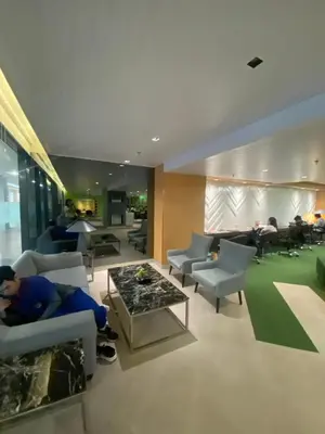 a living room with a person sitting on a couch at Beans Crib Staycation at SMDC Green 2 Residences in Dasmariñas