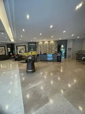 a lobby with a large room with flowers on the floor at Fame Residences EDSA Shaw MRT Shangrila Megamall in Manila