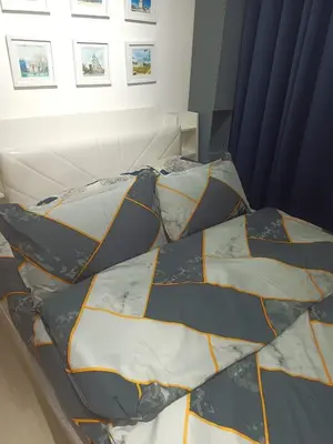 a bed with four pillows on it in a room at La Maison d'Antoine in Manila