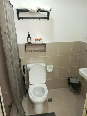 a small bathroom with a toilet and a sink at La Maison d'Antoine in Manila