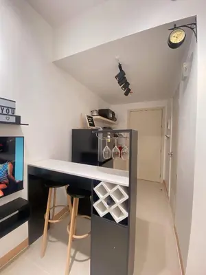 a small kitchen with a counter and a table at La Maison d'Antoine in Manila