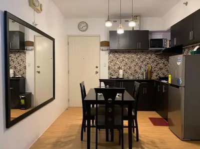 a kitchen with a table and chairs in a room at Condo In Manila in Manila