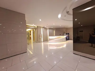 a lobby of a building with a person taking a picture at Grace Tower 3 in Manila