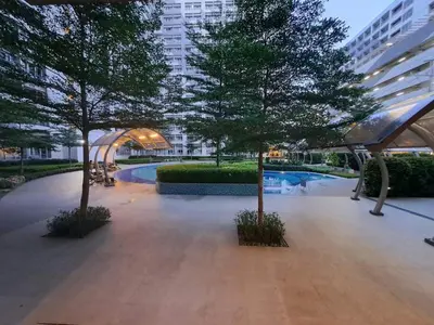 a courtyard with two trees and a swimming pool at Grace Tower 3 in Manila