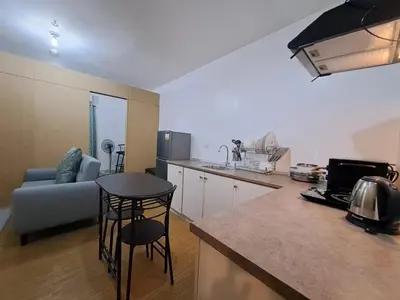a kitchen and living room with a couch and a table at Grace Tower 3 in Manila