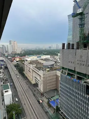 an overhead view of a city with traffic and buildings at Spacious 2-bedroom Corner Unit across Shangri-La in Manila