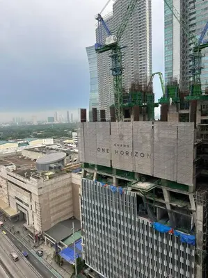 a building under construction in the middle of a city at Spacious 2-bedroom Corner Unit across Shangri-La in Manila