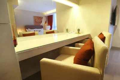 a living room with a couch and a table at Luxury Oasis in Makati with Balcony in Manila