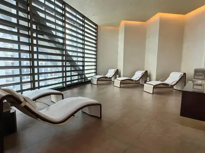 a waiting room with white chairs and large windows at Luxury Oasis in Makati with Balcony in Manila