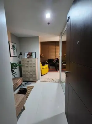 a living room with a white floor and a yellow door at Eastwood LeGrand 3 Eastwood City, Quezon City in Manila