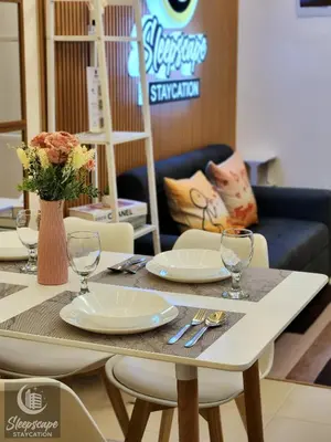 a table with plates and wine glasses on it at SleepScape Staycation in Manila