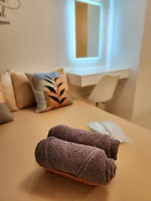 a bathroom with a towel laying on the floor at SleepScape Staycation in Manila