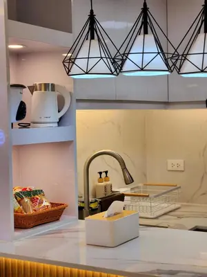 a kitchen with a sink and a counter top at SleepScape Staycation in Manila