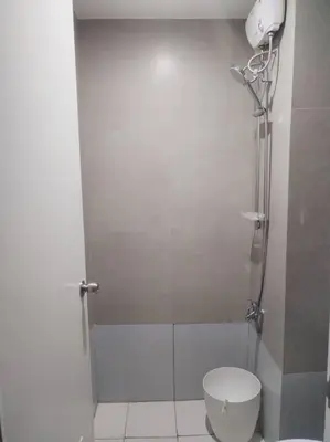 a bathroom with a shower stall with a toilet at Affordable Studio 2 Twin Beds - City View EDSA in Manila